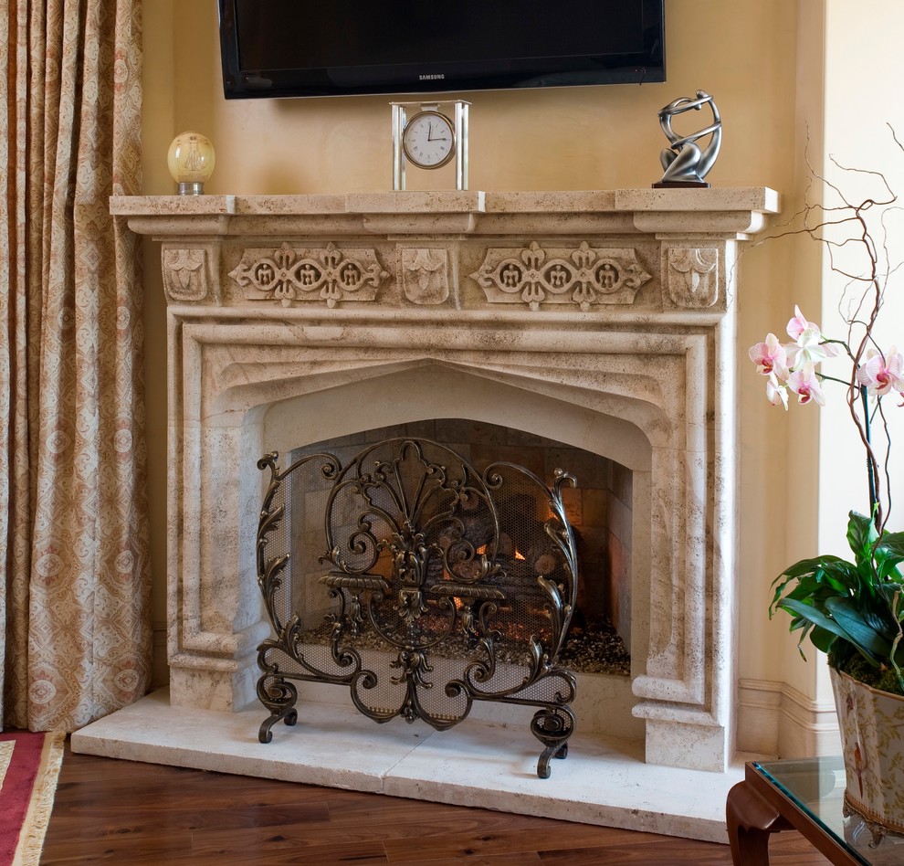 Photo of a family room in Los Angeles with a stone fireplace surround.