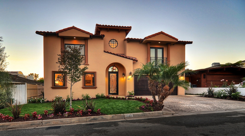 Inspiration for a large mediterranean two-storey stucco beige house exterior in Los Angeles with a hip roof and a tile roof.