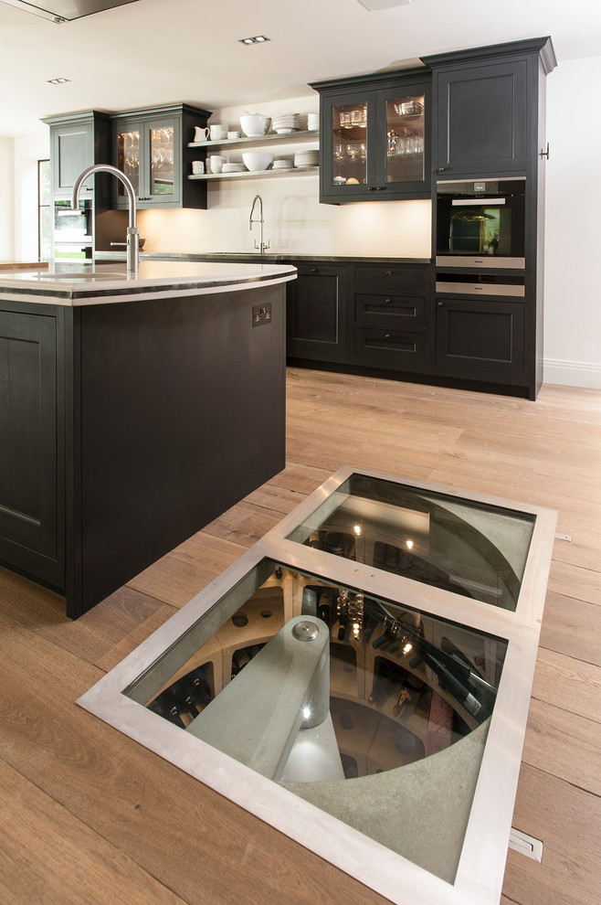Design ideas for a small contemporary kitchen in London with light hardwood floors.