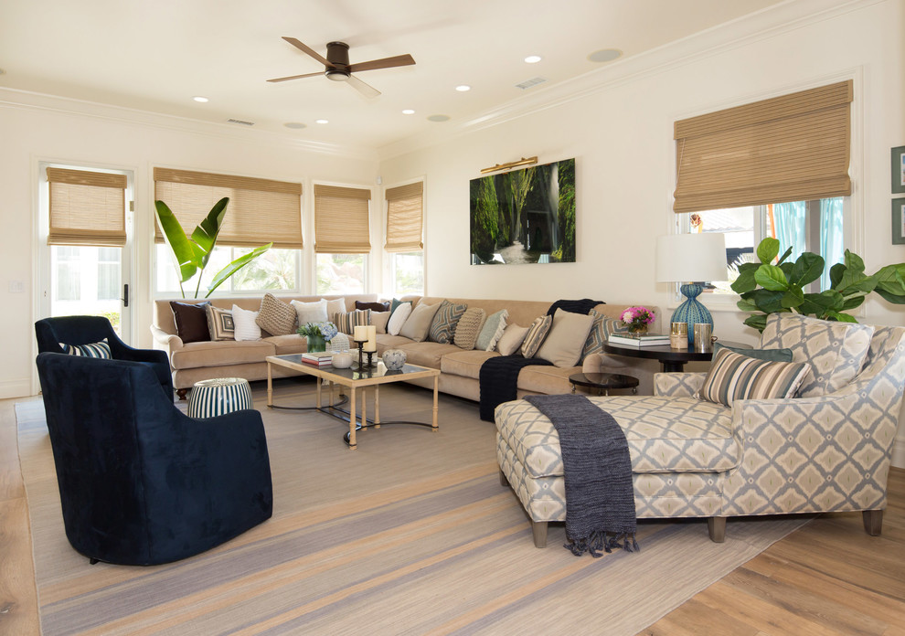 Inspiration for a large transitional living room in San Diego with white walls, medium hardwood floors and no tv.