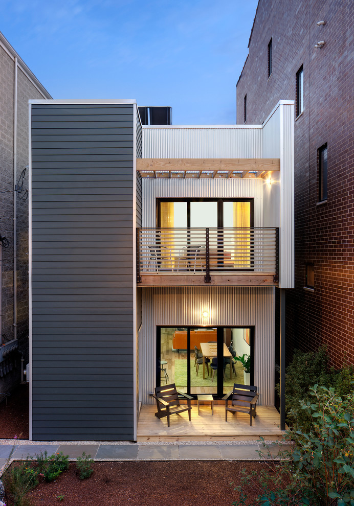 Contemporary two-storey grey exterior in Chicago with mixed siding and a flat roof.