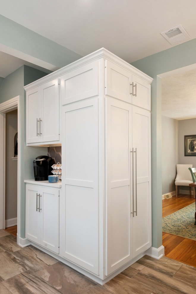 Small transitional u-shaped porcelain tile and beige floor kitchen pantry photo with recessed-panel cabinets, white cabinets, beige backsplash, stainless steel appliances, white countertops and quartz countertops