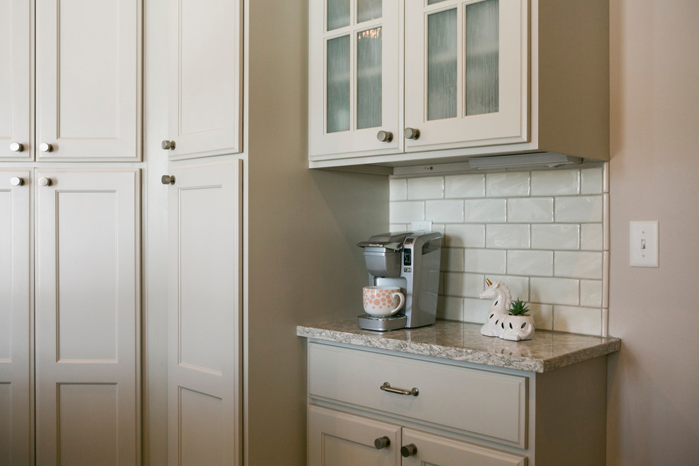 Inspiration for a mid-sized rustic l-shaped open concept kitchen remodel with raised-panel cabinets, white cabinets, granite countertops, white backsplash, subway tile backsplash, stainless steel appliances, an island and gray countertops