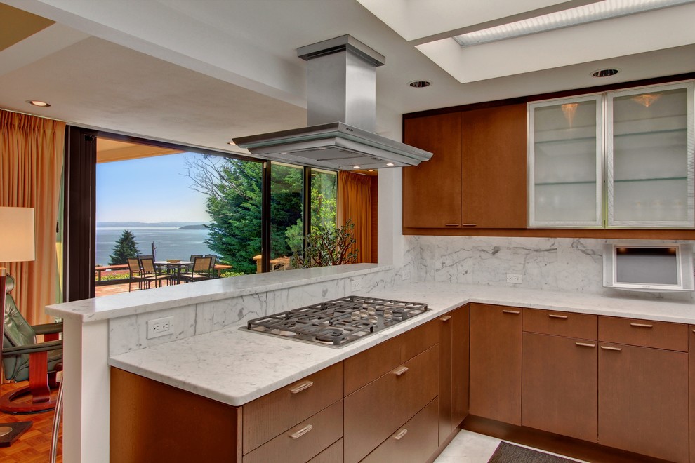 This is an example of a midcentury eat-in kitchen in Seattle with an undermount sink, flat-panel cabinets, medium wood cabinets, marble benchtops, stainless steel appliances and marble floors.