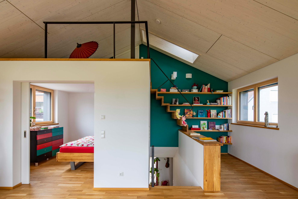 Danish open concept medium tone wood floor and wood ceiling living room photo in Munich