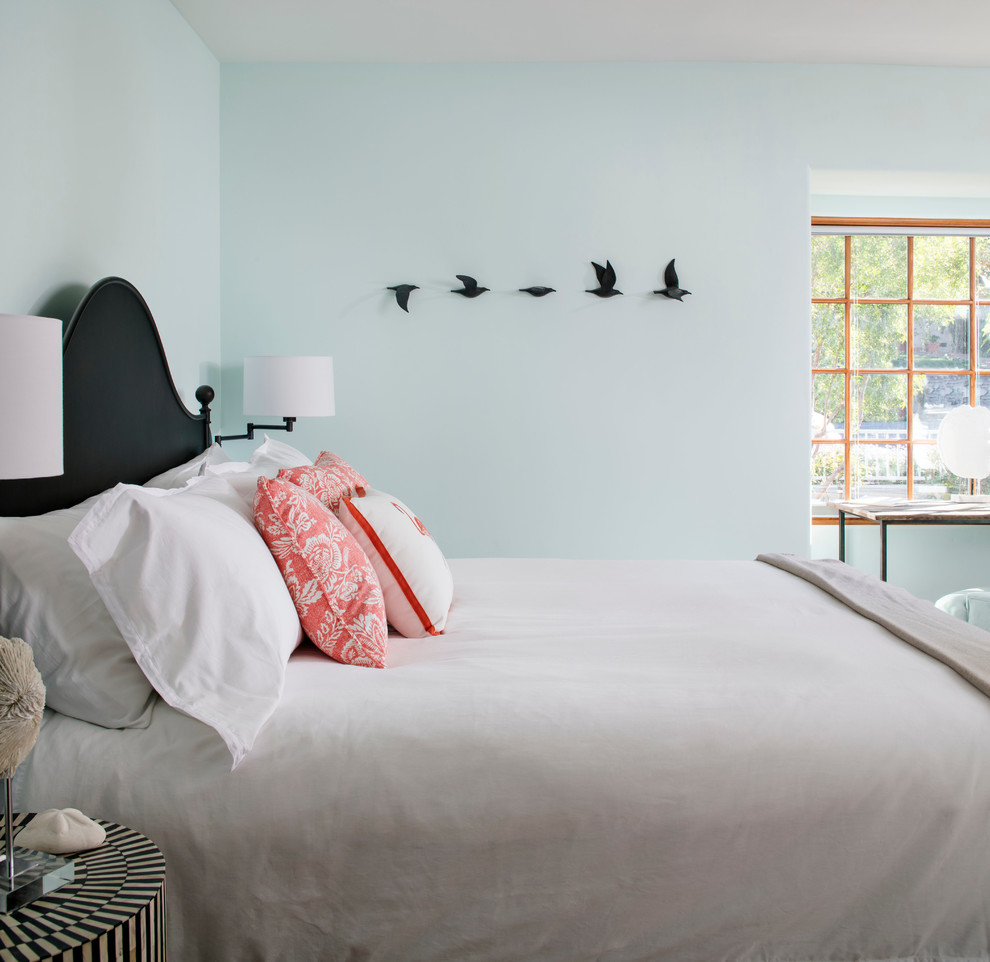 Inspiration for a mid-sized beach style guest bedroom in San Francisco with blue walls, medium hardwood floors and no fireplace.