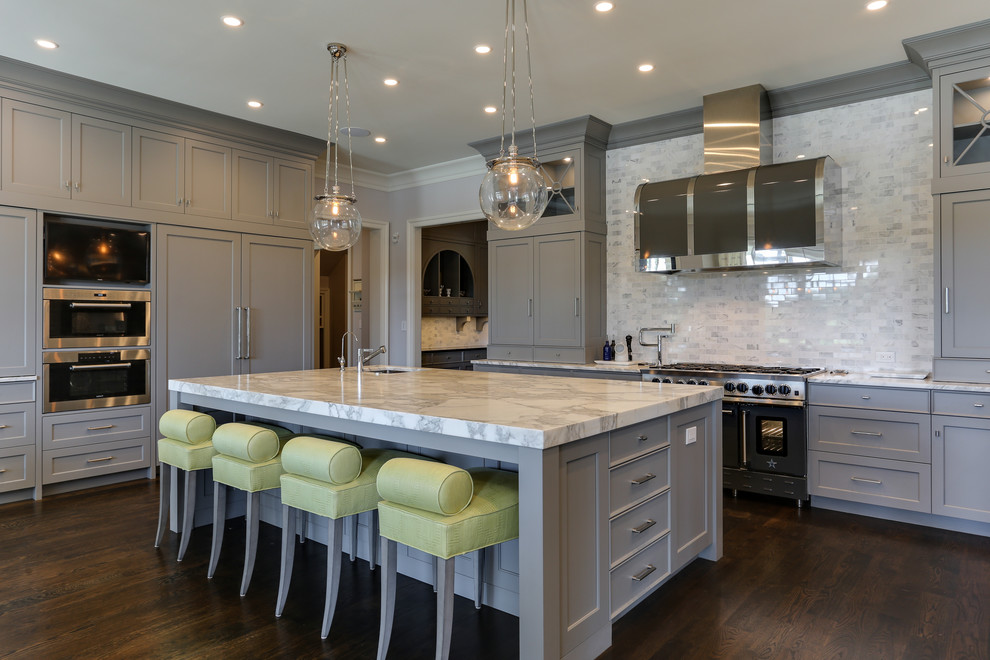 Photo of a transitional l-shaped kitchen in Raleigh with shaker cabinets, grey cabinets, white splashback, black appliances, dark hardwood floors and with island.