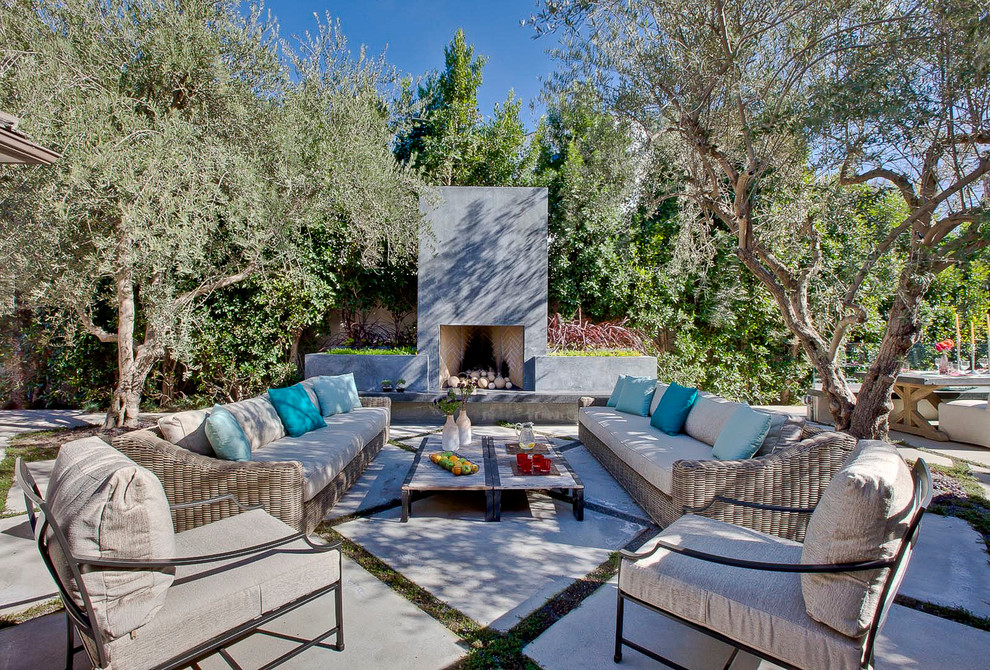 This is an example of a contemporary patio in Los Angeles with a fire feature and a pergola.