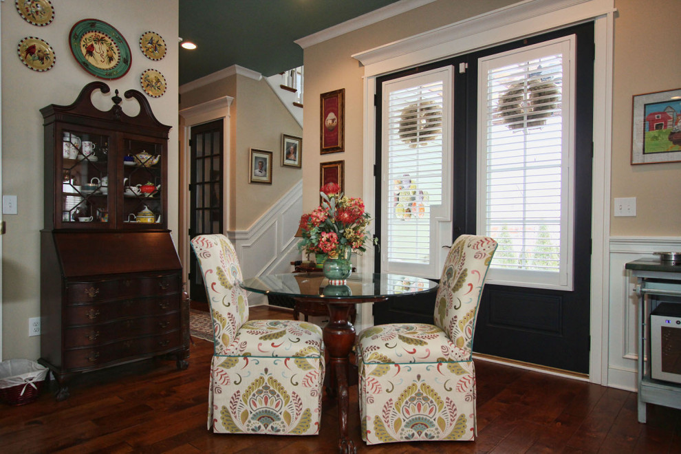 Inspiration for a traditional dining room in Louisville with beige walls, dark hardwood floors and brown floor.