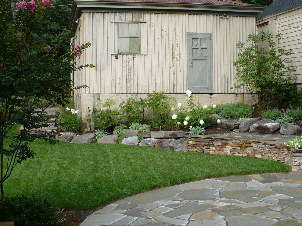 Mid-sized mountain style backyard stone patio photo in Baltimore