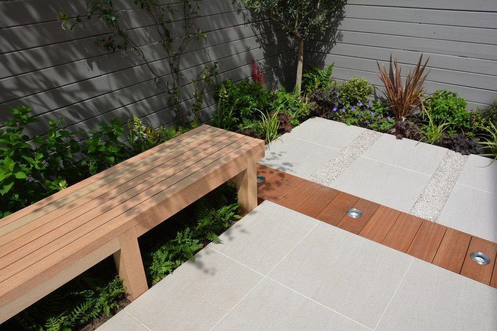 Design ideas for a small contemporary back partial sun garden for summer in London.