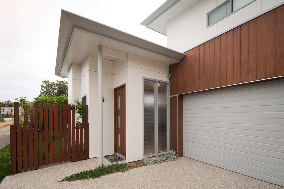 This is an example of a modern two-storey house exterior in Perth with wood siding, a flat roof and a metal roof.