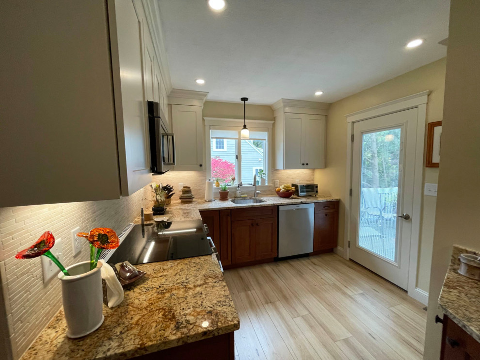 Mid-sized transitional l-shaped light wood floor and brown floor eat-in kitchen photo in Boston with an undermount sink, shaker cabinets, white cabinets, granite countertops, white backsplash, stone tile backsplash, stainless steel appliances, no island and brown countertops