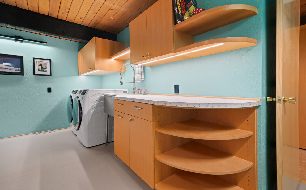 Retro utility room in Other with an utility sink, medium wood cabinets, laminate countertops, blue walls, lino flooring, a side by side washer and dryer, grey floors and multicoloured worktops.