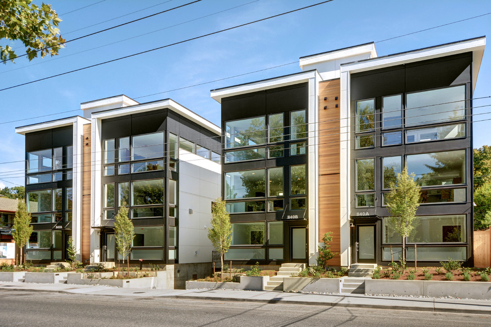 Inspiration for a large modern three-storey exterior in Seattle with mixed siding.