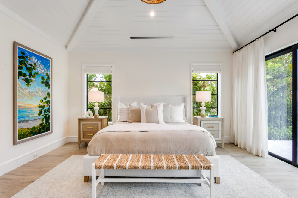 Inspiration for a mid-sized coastal master medium tone wood floor, beige floor and vaulted ceiling bedroom remodel in Miami with beige walls