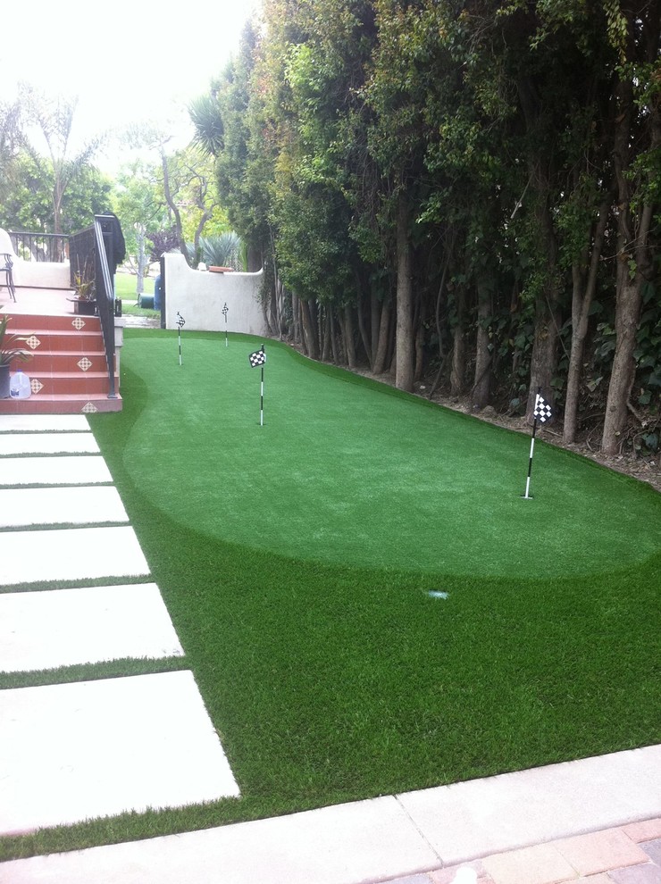 Inspiration for a mid-sized mediterranean backyard full sun outdoor sport court for spring in Los Angeles with with outdoor playset and gravel.
