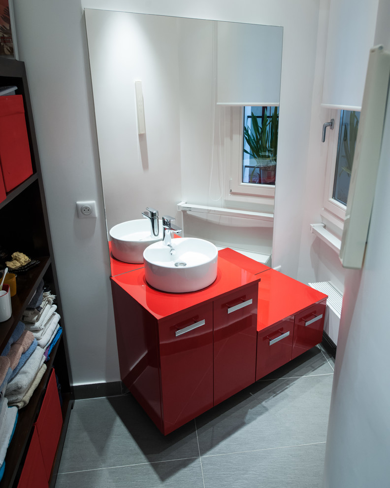 Photo of a small contemporary kids bathroom in Other with beaded inset cabinets, red cabinets, a curbless shower, gray tile, ceramic tile, white walls, ceramic floors, a drop-in sink and laminate benchtops.