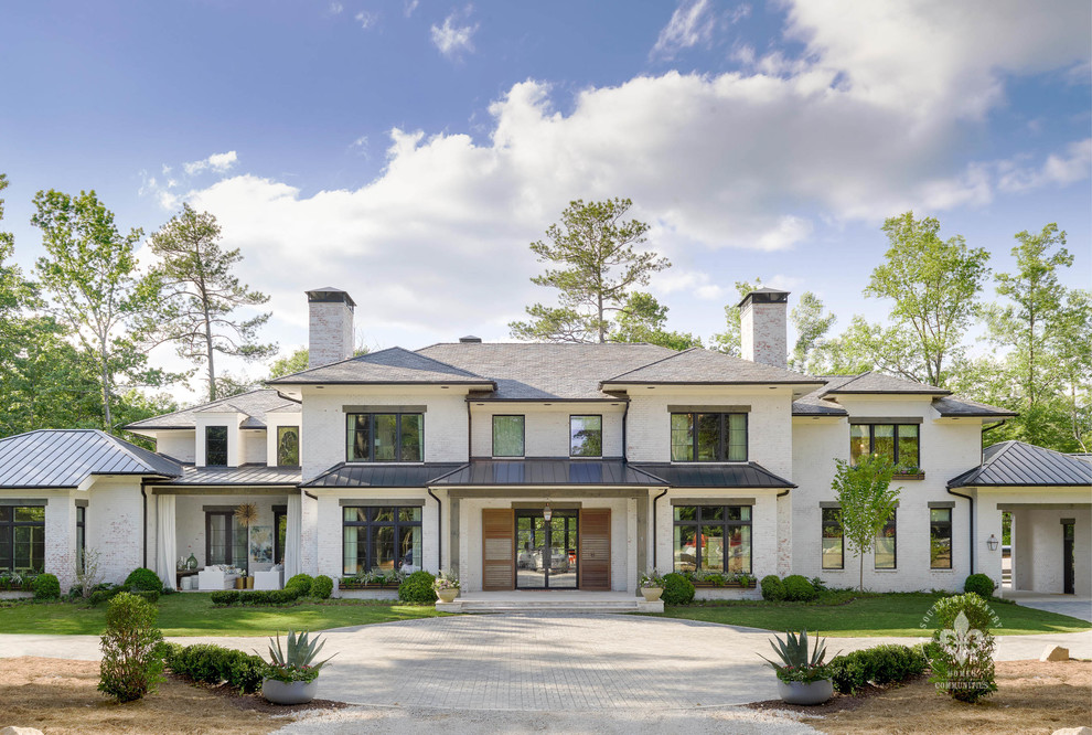 Design ideas for an expansive transitional three-storey brick white house exterior in Atlanta with a hip roof and a mixed roof.