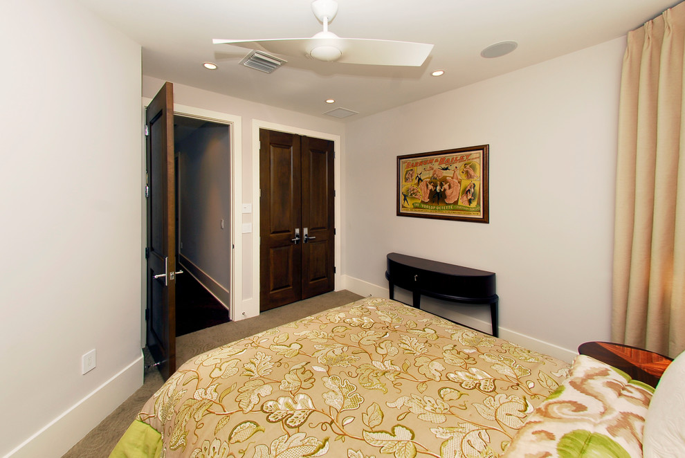 Photo of a large contemporary guest bedroom in Miami with grey walls and dark hardwood floors.