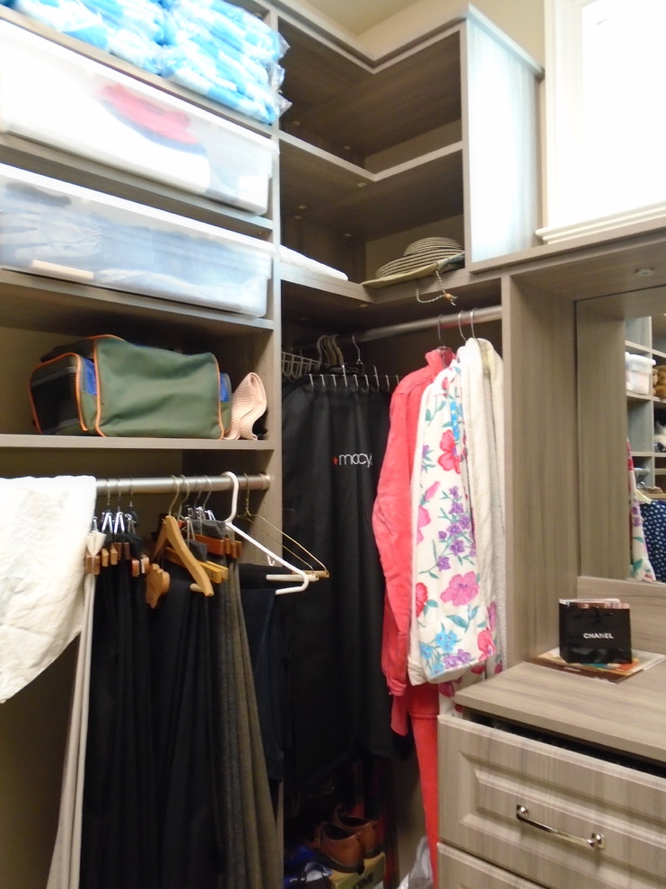 Photo of a large traditional gender-neutral walk-in wardrobe in Miami with raised-panel cabinets and grey cabinets.