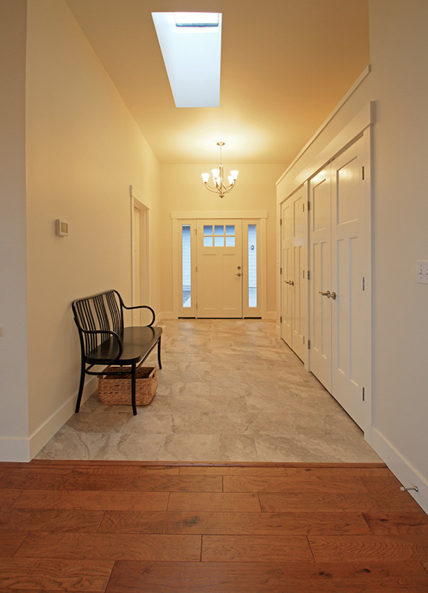 Mid-sized beach style foyer in Seattle with white walls, porcelain floors, a single front door and a white front door.