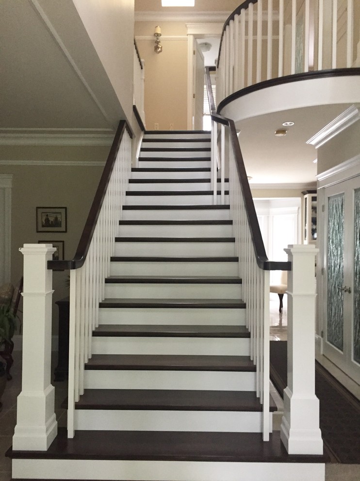 Design ideas for a large traditional wood straight staircase in Other with painted wood risers and wood railing.