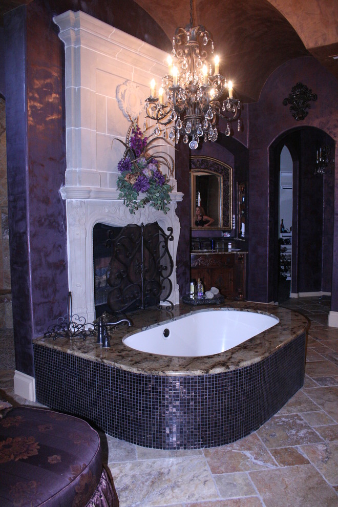 Design ideas for a mid-sized mediterranean master bathroom in Dallas with dark wood cabinets, beige tile, marble benchtops, a drop-in tub, stone slab, purple walls and limestone floors.