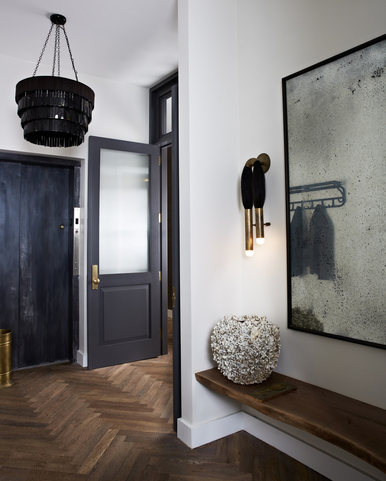 Industrial hallway in New York with white walls and medium hardwood floors.