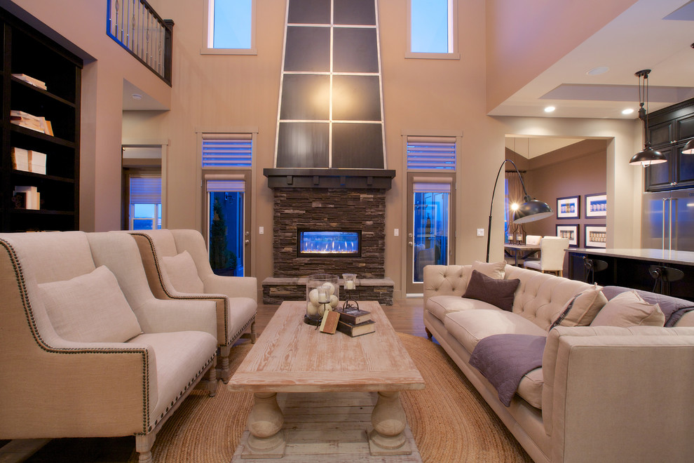 This is an example of a contemporary living room in Calgary with a stone fireplace surround.