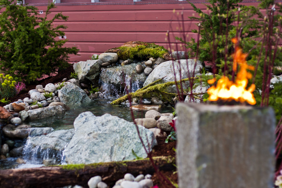 Inspiration for a mid-sized rustic partial sun backyard stone formal garden in Seattle for spring.