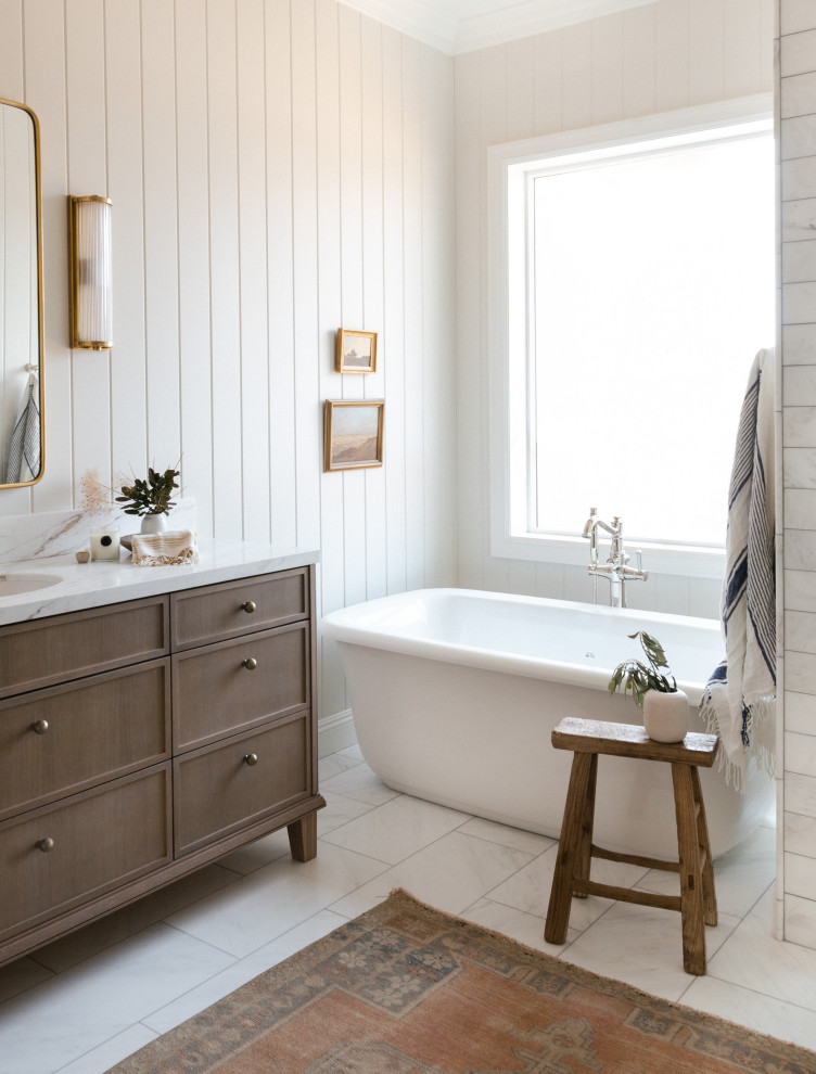 Example of a large transitional master marble tile marble floor, single-sink and shiplap wall bathroom design in Other with light wood cabinets, gray walls, an undermount sink, marble countertops, white countertops and a freestanding vanity