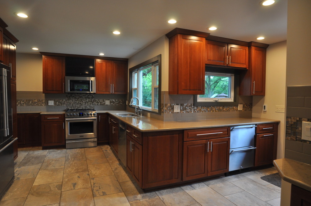 Example of a kitchen design in Chicago with stainless steel appliances and beige countertops