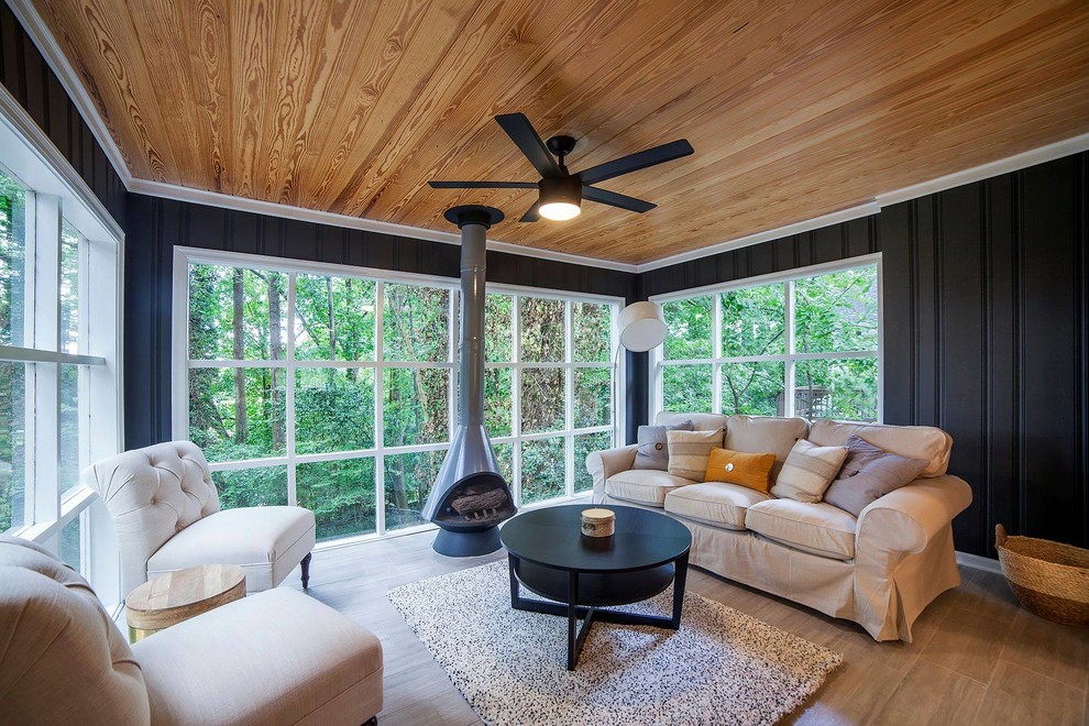Inspiration for a mid-sized contemporary sunroom in Atlanta with porcelain floors, a hanging fireplace, a metal fireplace surround, a standard ceiling and brown floor.