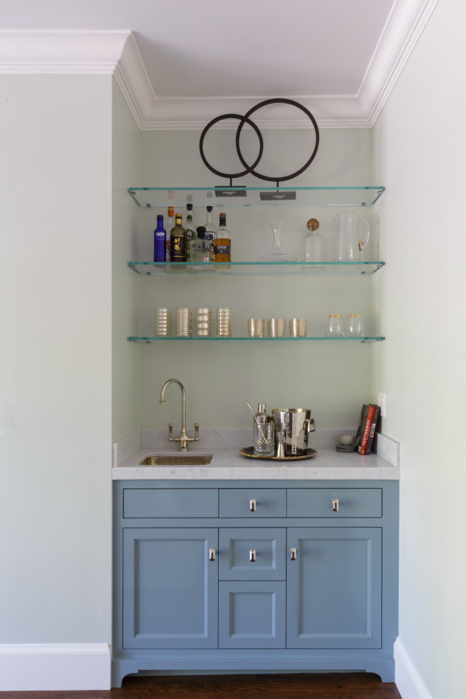 Mid-sized traditional wet bar in San Francisco with an undermount sink, recessed-panel cabinets, blue cabinets, marble benchtops, white splashback, marble splashback, dark hardwood floors, brown floor and white benchtop.