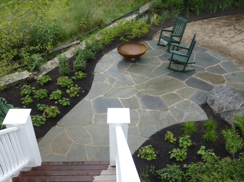 Inspiration for a traditional backyard patio in Portland Maine with natural stone pavers.
