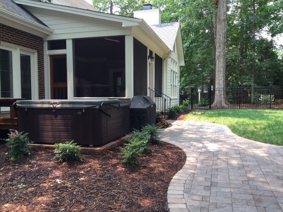 Inspiration for a mid-sized transitional backyard screened-in verandah in Raleigh with tile and a roof extension.