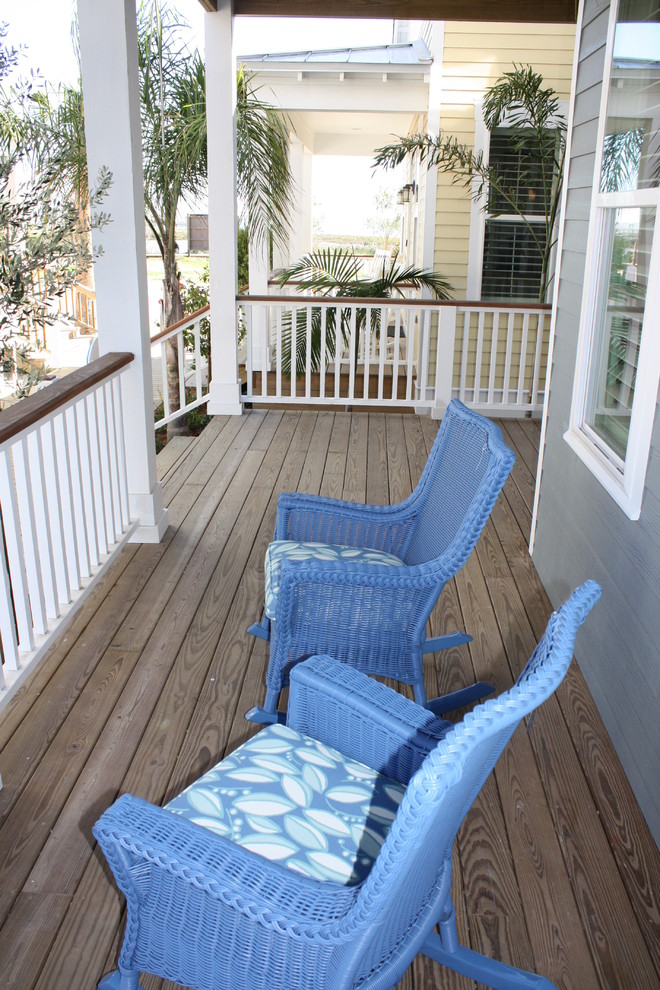 Design ideas for a mid-sized beach style front yard verandah in Austin with decking and an awning.