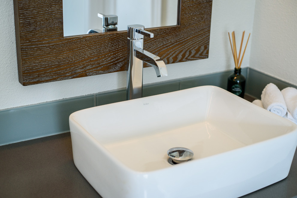Inspiration for a large transitional master gray tile and glass tile concrete floor drop-in bathtub remodel in Denver with shaker cabinets, white cabinets, white walls, a vessel sink and quartz countertops
