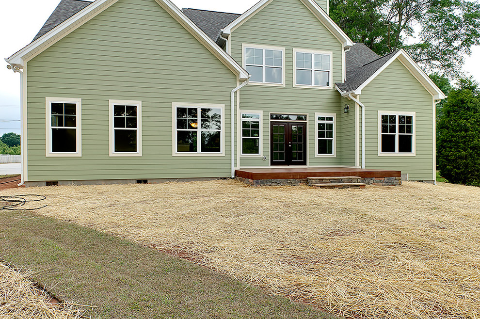 Transitional green two-story exterior home idea