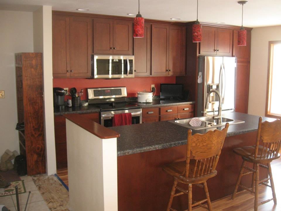 Eat-in kitchen - eat-in kitchen idea with dark wood cabinets and quartz countertops