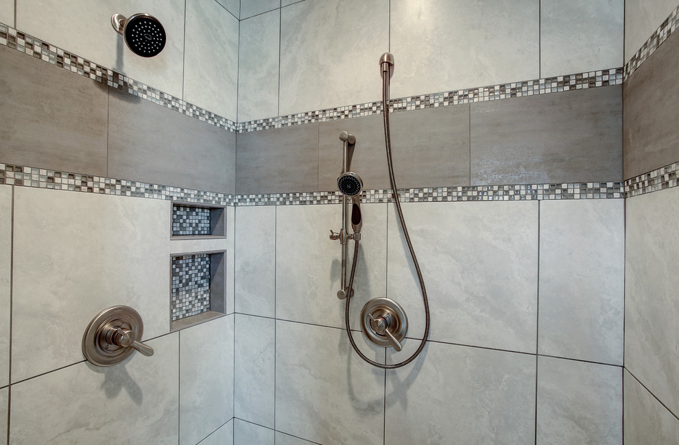 This is an example of a small arts and crafts master bathroom in Grand Rapids with shaker cabinets, medium wood cabinets, gray tile, mosaic tile, blue walls, medium hardwood floors, an undermount sink, solid surface benchtops, beige floor and a hinged shower door.