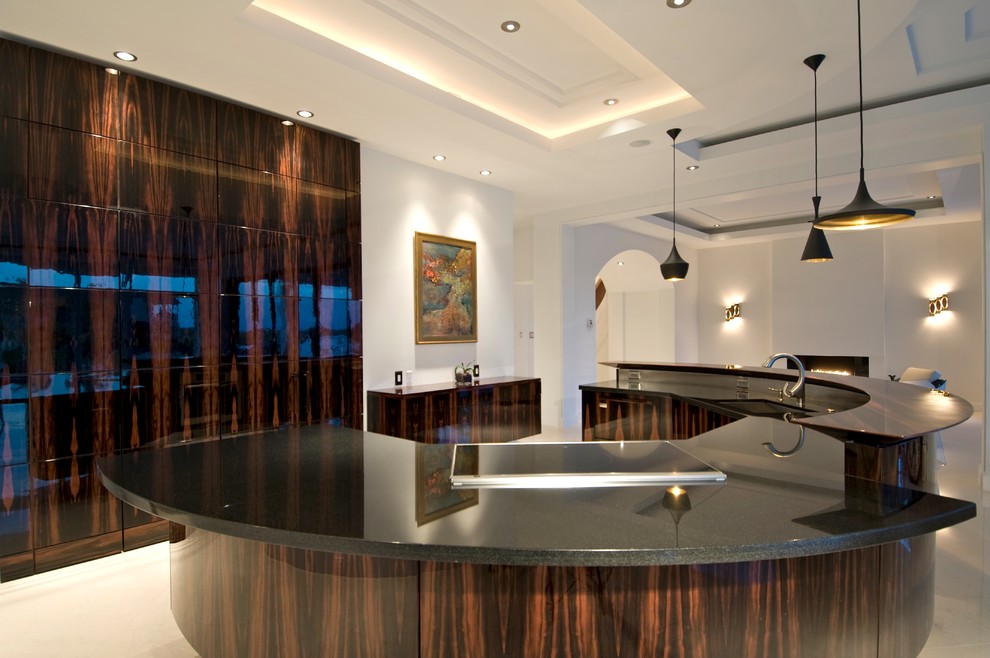 Photo of a contemporary kitchen in Miami with flat-panel cabinets and dark wood cabinets.