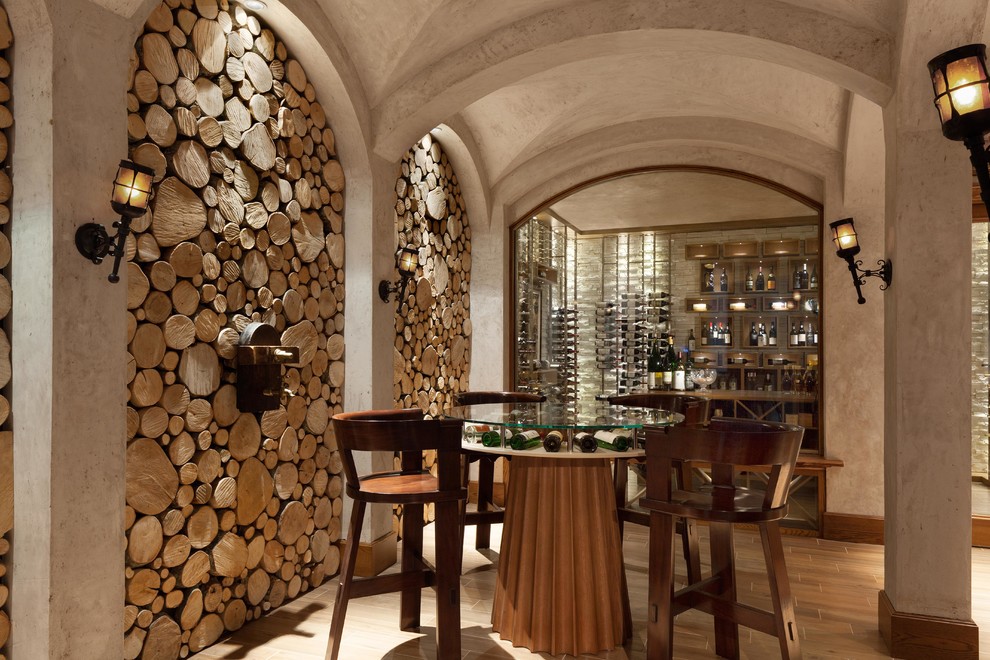Design ideas for an expansive mediterranean wine cellar in Tampa with storage racks and light hardwood floors.
