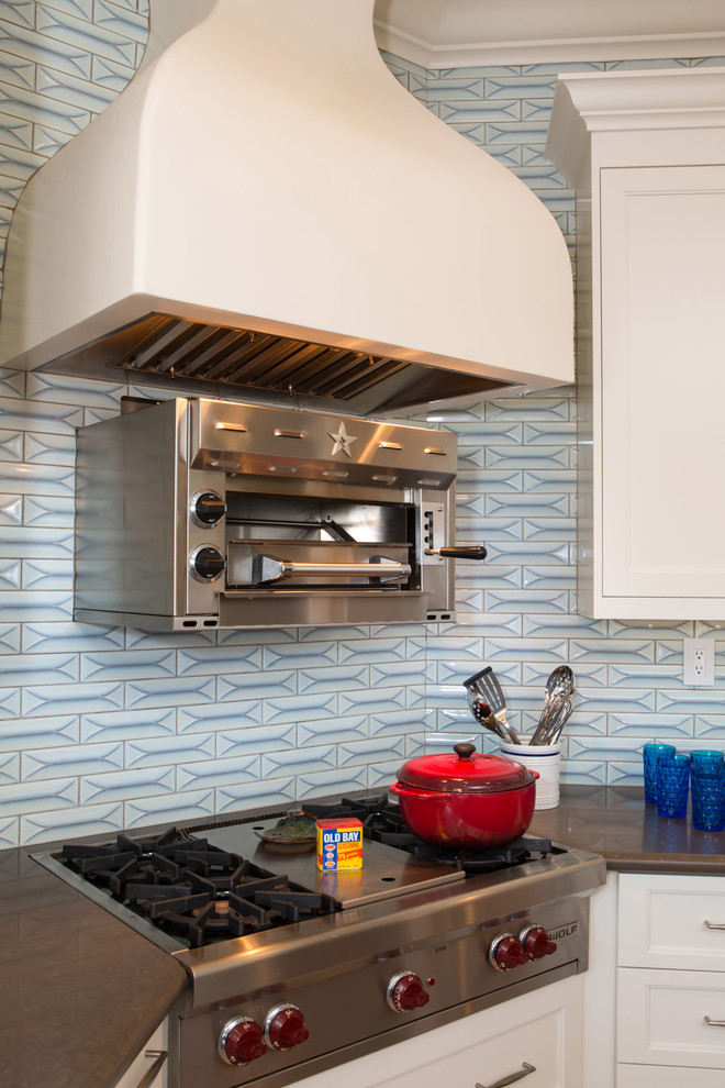 Open concept kitchen - large transitional u-shaped medium tone wood floor open concept kitchen idea in Los Angeles with a farmhouse sink, shaker cabinets, white cabinets, quartz countertops, blue backsplash, ceramic backsplash, stainless steel appliances and an island