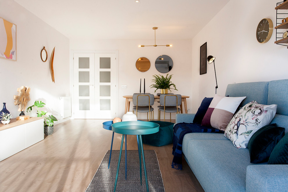 Photo of a mid-sized scandinavian formal enclosed living room in Barcelona with white walls, light hardwood floors, no fireplace and beige floor.