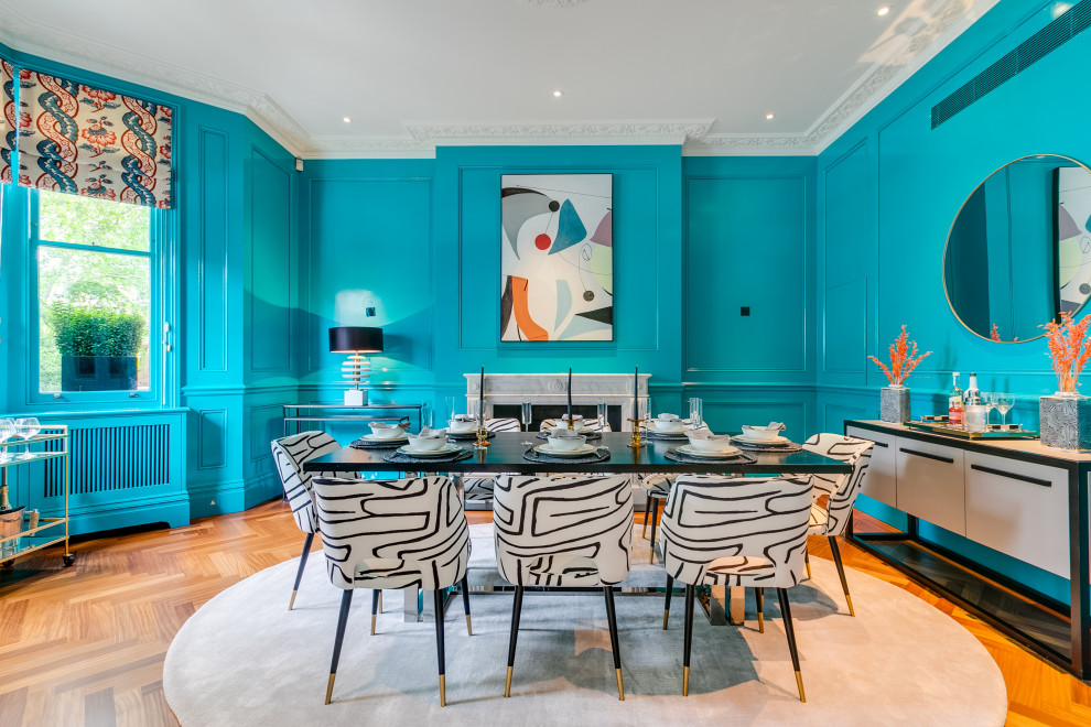 Large eclectic dining room in London with banquette seating and blue walls.