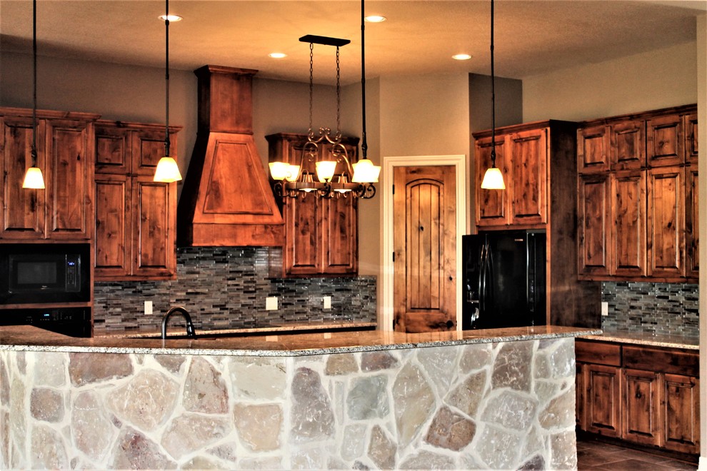 Inspiration for a large rustic u-shaped porcelain tile and beige floor kitchen remodel with an undermount sink, raised-panel cabinets, medium tone wood cabinets, granite countertops, multicolored backsplash, glass tile backsplash, black appliances, an island and multicolored countertops