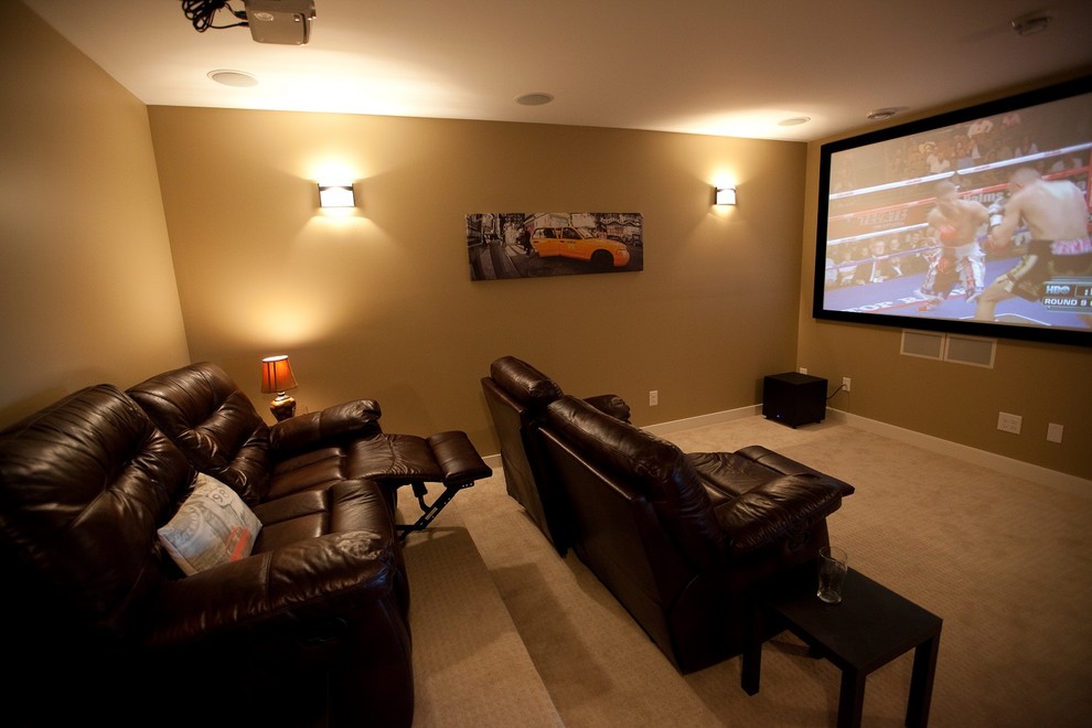 Photo of a large arts and crafts enclosed home theatre in Other with beige walls, carpet and a projector screen.