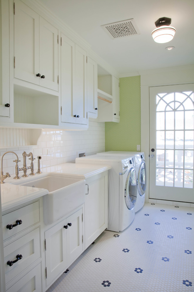 Beach style dedicated laundry room in San Diego with a farmhouse sink, white cabinets, green walls, ceramic floors, a side-by-side washer and dryer and beaded inset cabinets.